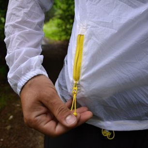 Praktická kapsa na zip při běhu slouží k uložení drobností, bunda se do ní dá celá sbalit.